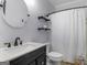Bathroom with shiplap walls, a round mirror, and a shower, offering a cozy and modern feel at 142 Gillson Dr, Mcdonough, GA 30253