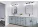 Bathroom with double vanity, modern mirrors, and white countertop, offering a clean and stylish space at 142 Gillson Dr, Mcdonough, GA 30253