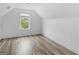 Bedroom featuring bright walls, wood-look floors, and a window, offering a cozy space at 142 Gillson Dr, Mcdonough, GA 30253