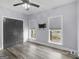 Bedroom featuring light-colored walls, wood-look flooring, and bright windows, offering a calm space at 142 Gillson Dr, Mcdonough, GA 30253