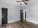 Bedroom featuring dark doors, wood-look floors, and neutral walls, creating a modern space at 142 Gillson Dr, Mcdonough, GA 30253