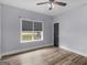 Bedroom with natural light from the window, wood-look floors, and a neutral wall paint at 142 Gillson Dr, Mcdonough, GA 30253