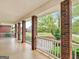 Spacious covered porch with brick columns, offering a serene outdoor living space at 142 Gillson Dr, Mcdonough, GA 30253