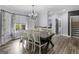 Dining room with hardwood floors, a chandelier, and large windows that provide natural light at 142 Gillson Dr, Mcdonough, GA 30253