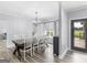 Bright dining room with backyard access features hardwood floors, a chandelier, and many chairs at 142 Gillson Dr, Mcdonough, GA 30253