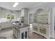 Spacious kitchen boasts white cabinets, stainless appliances, a butcher block island, and open layout at 142 Gillson Dr, Mcdonough, GA 30253
