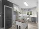 Bright kitchen with white cabinets, an island, and stainless steel appliances at 142 Gillson Dr, Mcdonough, GA 30253