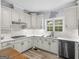 Well-appointed kitchen featuring white cabinets, subway tile backsplash, and a modern sink at 142 Gillson Dr, Mcdonough, GA 30253