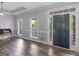 Bright living room with wood floors, a tray ceiling, and large windows at 142 Gillson Dr, Mcdonough, GA 30253