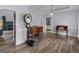 Stylish living room featuring wood floors, elegant trim, and a view to the fireplace at 142 Gillson Dr, Mcdonough, GA 30253