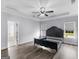 Spacious main bedroom with a ceiling fan, hardwood floors, and a connecting bathroom at 142 Gillson Dr, Mcdonough, GA 30253