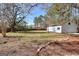 Large, open backyard with a shed, mature trees, and lush grass at 6316 Rockland Rd, Lithonia, GA 30038