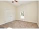 Bright bedroom features neutral paint, carpet, ceiling fan and double door closet at 6316 Rockland Rd, Lithonia, GA 30038