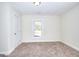 Cozy bedroom with carpet, neutral walls, featuring a white door and ample natural light at 6316 Rockland Rd, Lithonia, GA 30038