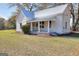 Charming home with a new metal roof and inviting front porch presents a beautiful curb appeal at 6316 Rockland Rd, Lithonia, GA 30038