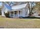 Charming one-story home with a covered porch and metal roof nestled among mature trees at 6316 Rockland Rd, Lithonia, GA 30038