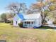 Charming home with a metal roof, a cozy front porch, and an outbuilding for all your storage needs at 6316 Rockland Rd, Lithonia, GA 30038