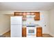 Kitchen features white appliances, stone-look counters, and wood cabinets at 6316 Rockland Rd, Lithonia, GA 30038
