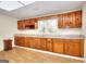 Eat-in kitchen offers wood cabinets, durable countertops, window, and vinyl flooring at 6316 Rockland Rd, Lithonia, GA 30038