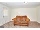 Inviting room featuring a vintage sofa with patterned pillows and carpeted floor at 6316 Rockland Rd, Lithonia, GA 30038