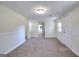 Expansive living room with fresh carpet, neutral walls, and access to multiple rooms at 6316 Rockland Rd, Lithonia, GA 30038