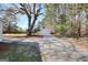 Spacious outbuilding with white painted wood and gravel driveway provides plenty of storage space at 6316 Rockland Rd, Lithonia, GA 30038