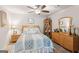 Comfortable bedroom with a ceiling fan, neutral color palette, and natural wood furniture at 4365 Sunflower Cir, Cumming, GA 30040