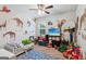 Fun bedroom featuring animal decals, toys, and a play area with a TV and a comfortable toddler bed at 4365 Sunflower Cir, Cumming, GA 30040
