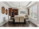 Dining room featuring tray ceilings, wood floors, elegant furniture, and window with shutters at 4365 Sunflower Cir, Cumming, GA 30040