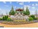Community entrance sign with a waterfall feature, landscaping, and vibrant floral displays at 4365 Sunflower Cir, Cumming, GA 30040