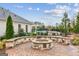 Outdoor stone fire pit on a brick patio, surrounded by lush landscaping at 4365 Sunflower Cir, Cumming, GA 30040