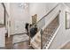 Elegant foyer with high ceilings, wood floors, and staircase with black iron railings at 4365 Sunflower Cir, Cumming, GA 30040