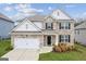 Charming two-story home with well-maintained lawn and landscaping features a two car garage at 4365 Sunflower Cir, Cumming, GA 30040