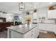 Open kitchen area with hardwood floors, recessed lighting, an island, stainless steel appliances, and seating at 4365 Sunflower Cir, Cumming, GA 30040