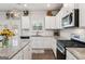 Bright and functional kitchen with stainless steel appliances, white cabinetry, and granite countertops at 4365 Sunflower Cir, Cumming, GA 30040