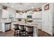 Gorgeous kitchen boasts granite countertops, stainless appliances, bright lighting, and island seating at 4365 Sunflower Cir, Cumming, GA 30040