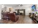 Inviting living room featuring a cozy fireplace, TV, ceiling fan and gleaming hardwood floors at 4365 Sunflower Cir, Cumming, GA 30040