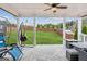 Relaxing covered patio features stone flooring, a ceiling fan, and a spacious backyard with a privacy fence at 4365 Sunflower Cir, Cumming, GA 30040