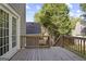 Wood deck with railings provides an outdoor living space adjacent to the backyard with mature trees at 109 Bowen Cir, Atlanta, GA 30313