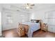 Bright bedroom features hardwood floors, ceiling fan, and plenty of natural light from the large windows at 109 Bowen Cir, Atlanta, GA 30313