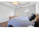 Primary bedroom featuring a large bed, tray ceilings, neutral paint, and windows with blinds at 109 Bowen Cir, Atlanta, GA 30313