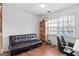 Bedroom with a black leather futon, built-in shelving unit, and a computer chair at a desk at 109 Bowen Cir, Atlanta, GA 30313