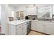 Bright kitchen with white cabinets, stainless steel appliances, granite counters, and tile floors at 109 Bowen Cir, Atlanta, GA 30313