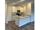 Modern kitchen featuring white cabinetry, granite countertops, stainless steel appliances, and hard floors at 8642 Lakeview Commons # 36, Jonesboro, GA 30238