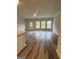 Open concept living area with hardwood flooring, neutral walls, and natural light at 8642 Lakeview Commons # 36, Jonesboro, GA 30238