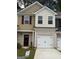 Attractive townhome exterior with a brick base, garage, neutral siding, and complementing landscaping at 8660 Lakeview Commons # 39, Jonesboro, GA 30238
