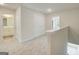 Bright hallway with carpet flooring, linen closet and access to other rooms of the home at 8660 Lakeview Commons # 39, Jonesboro, GA 30238