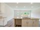 Open kitchen with a center island, granite counters, white cabinets and stainless steel faucet at 8660 Lakeview Commons # 39, Jonesboro, GA 30238