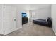 Carpeted bedroom with closet, dresser and TV with window at 605 Camano Way, Mcdonough, GA 30253
