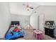 Bedroom with carpeted floors and a cute play area at 605 Camano Way, Mcdonough, GA 30253
